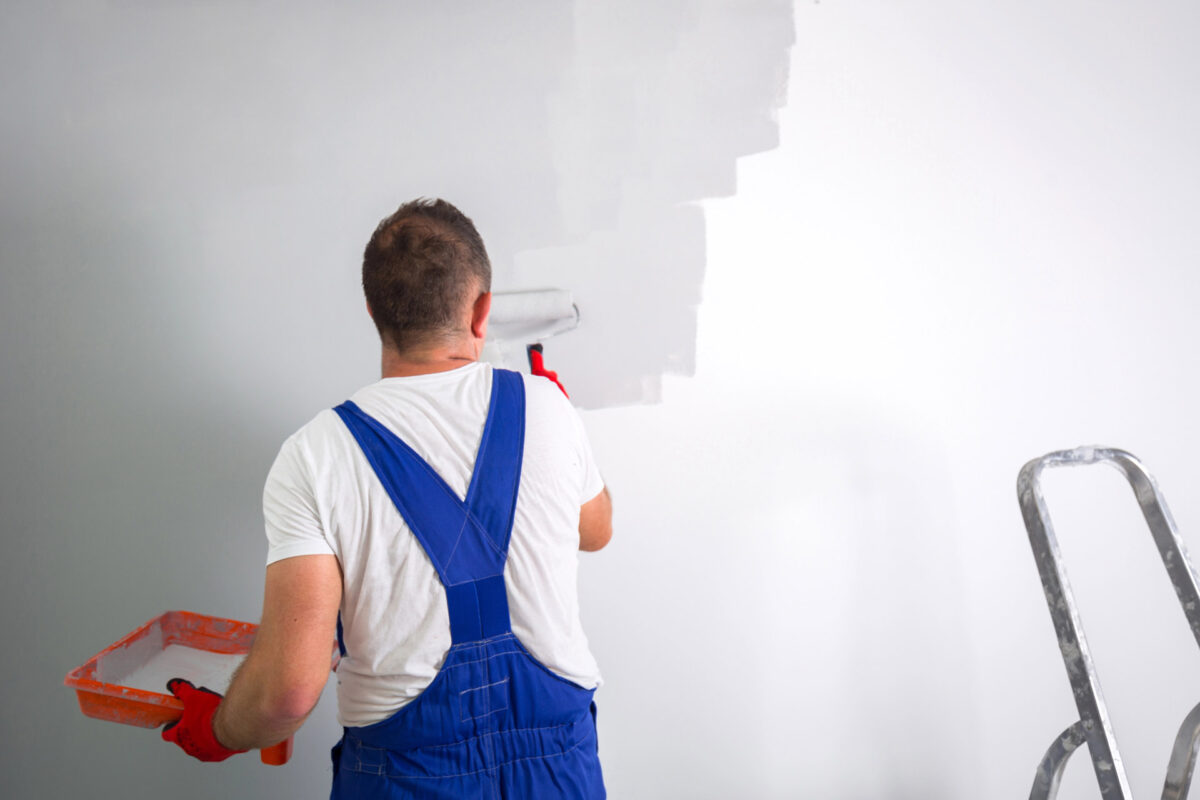 Residential painter rolling paint onto an interior wall in Girard, OH