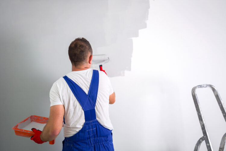 Residential painter rolling paint onto an interior wall in Girard, OH